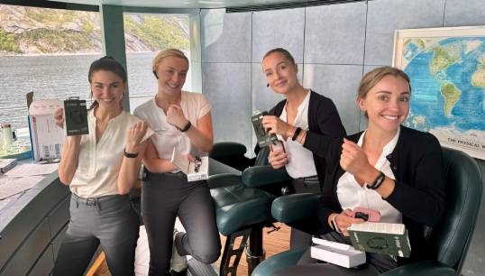 Yacht crew from the Savannah, including Jo De Luca (first left) display the Fitbit wrist watches they have worn throughout the SIM project. Image: SY Savannah Image:Yacht crew from the Savannah, including Jo De Luca (first left) display the Fitbit wrist watches they have worn throughout the SIM project. Image: SY Savannah