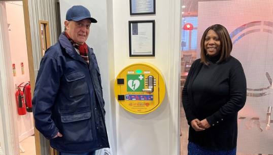 L-R: QVSR Resident Leonard Hann and staff member Claudette Cummings inspect one of the AED's that has already been installed at the QVSR in London by the SHS. Image: QVSR Image:L-R: QVSR Resident Leonard Hann and staff member Claudette Cummings inspect one of the AED's that has already been installed at the QVSR in London by the SHS. Image: QVSR