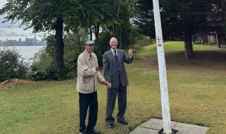 Flag-raising Mariners' Park residents (from left) Gary Dickinson and Alex Harrison. Image:Flag-raising Mariners' Park residents (from left) Gary Dickinson and Alex Harrison.
