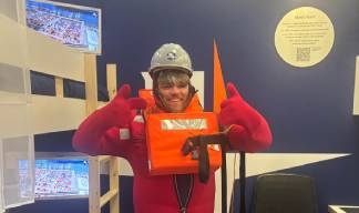 John Whitcher of Fuel Poverty Action during a safety drill challenge in the Nautilus ship's cabin stand. Image:John Whitcher of Fuel Poverty Action during a safety drill challenge in the Nautilus ship's cabin stand.